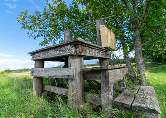 landscape with old wooden sticks, old wooden structure, historical milk jug collection place