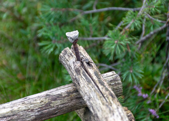 an old wooden structure with a rusty iron screw