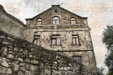 The facade of an old building was damaged by bullets and artille