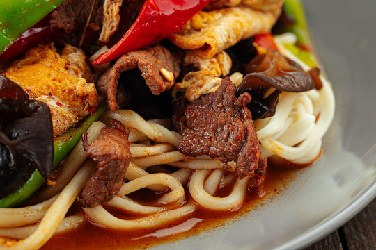 Closeup on uyghur dish guiru lagman noodles with ear mushrooms