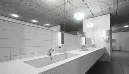 Public restroom with sinks faucets and mirrors - obrazy, fototapety, plakaty