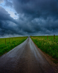 Fototapeta na wymiar Spring storm clouds over Hampshire hills and lanes, South Downs National Park, UK
