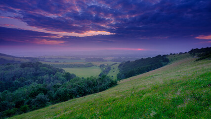 Fototapeta na wymiar Summer sunset over the Meon Valley towards Beacon Hill from Old Winchester Hill, South Downs National Park, Hampshire, UK