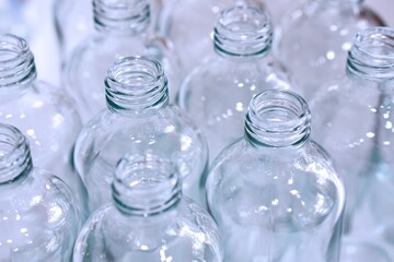 Close up of clean empty glass bottles for packing and contain.   