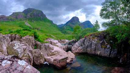 Fototapeta na wymiar The Three Sisters of Glencoe with the waterfalls near the Study, Scotland