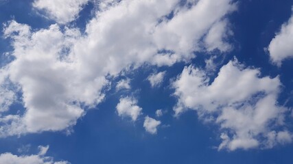 White cloudy and bright blue sky in sunny day as background.