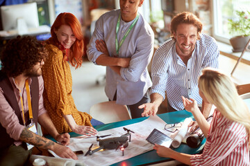  team working on plan to shoot commercial video with drone, having fun on their job