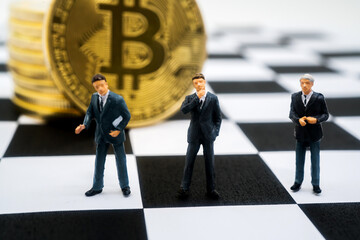 miniature businessmen and the bitcoin currency	
