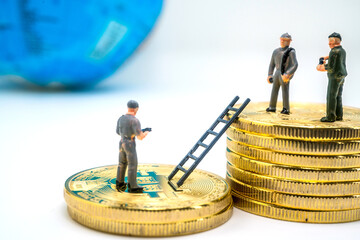 miniature businessman and worker standing at the  bitcoin, future currency	
