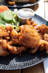 Dutch street food, fried pieces of cod fish fillet served with garlic sauce and fresh green salade