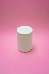 White jar on a pink background for cosmetics