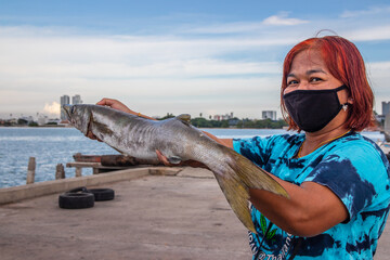 The Woman and the freshly caught fish