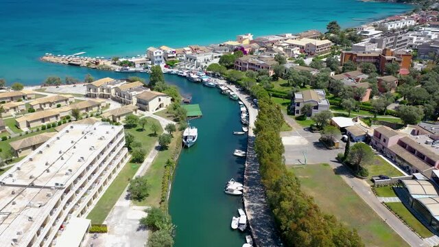 Water channel between Moraitika and Messonghi villages, Corfu Island in Greece, view with Messonghi Beach holiday resort on left side, 4k drone video