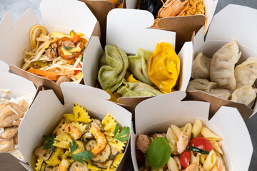 Сhinese takeaway food, italian food delivery. Different lunch wok box with dumplings, noodles with...