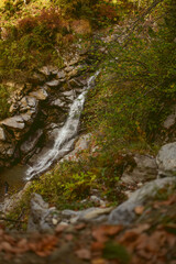Waterfall in autumn forest. Russia