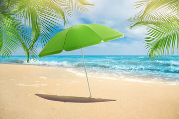 Fototapeta na wymiar Open big beach umbrella on sandy coast