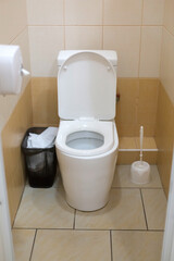 Close up of a clean white toilet bowl in a toilet room. Hygiene standards of a public institution