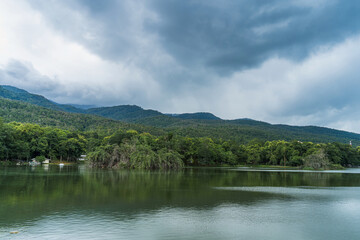 Fototapeta na wymiar landscape lake views at Ang Kaew Chiang Mai University in nature forest Mountain views spring cloudy sky background with white cloud.