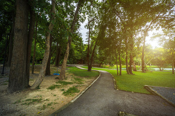 Road pathway in the park for relaxing walking jogging landscape lake views at Ang Kaew Chiang Mai University in nature forest Mountain views spring blue sky background with white cloud.
