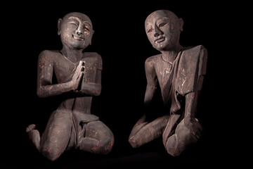 Fototapeta premium Buddhist monks in peaceful meditation. Traditional vintage Thai buddhism statues