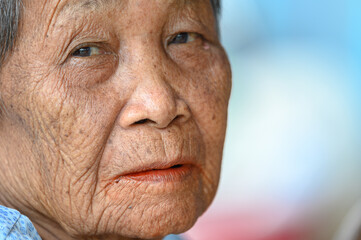 close-up wrinkled old Asian woman's face was smiling happily.Concept: happiness and hope