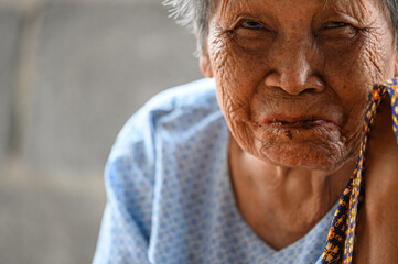 close-up wrinkled old Asian woman's face was smiling happily.Concept: happiness and hope