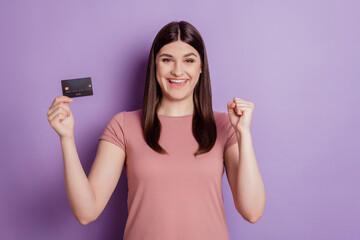 Photo of attractive young girl happy positvie smile rejoice victory success income credit card isolated violet color background