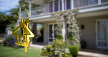 House keys and key fob hanging over out of focus house 4k