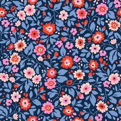 Vintage floral background. Floral pattern with small colorful flowers on a blue background. Seamless pattern for design and fashion prints. Ditsy style. Stock vector illustration.