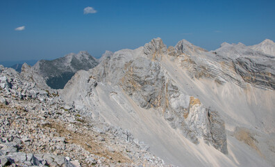 bare alpine peaks shining in the summer sun with a background of mountain ridges