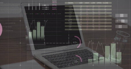 Statistical data processing over grid network against laptop and glass of water on wooden surface