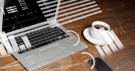Statistical data processing against laptop and coffee cup on wooden surface