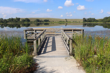 Wooden deck on the lake with beautiful nature view. Summer background.