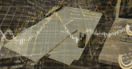 Image of financial data processing over desk with notebook and laptop