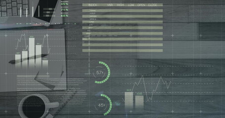 Image of financial data processing, statistics over desk with notebook, smartphone and laptop