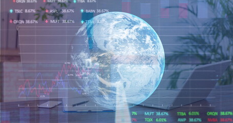 Digital composite image of stock market data processing over globe against office desk