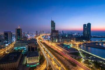 Aerial view of Manama skyline after sunset and newly constructed modern buildings with beautiful lights.