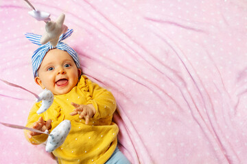 Baby girl laugh with mobile toys view from above