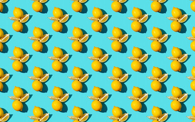 Trendy sunlight Summer pattern made with yellow lemon slice on bright light blue background....