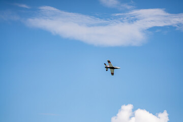Fototapeta na wymiar Remote controlled aircraft flying on blue sky