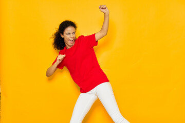Fototapeta na wymiar woman in red t-shirt emotions fun yellow background
