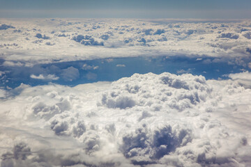 Fototapeta na wymiar View from plane window on a white cloudscape durin flight