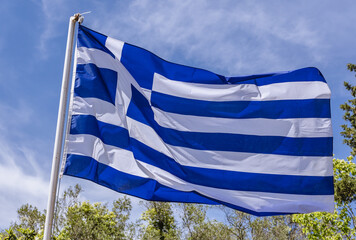 Greek flag fluttering on a wind, Corfu Island, Greece