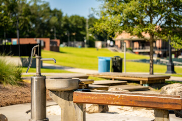 Fototapeta na wymiar Hand pump water fountain in the park scene