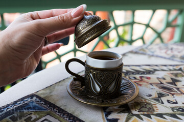 Traditional Turkish coffee. Oriental coffee on the table in a copper cup. Tbilisi, Georgia.