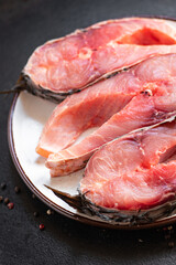 fresh raw fish carp white fish headless carcass meal snack on the table copy space food background rustic. top view keto or paleo diet pescetarian