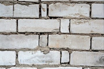 The brick wall is made of bricks and fragments of bricks