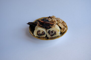 dried fruits and nuts roll. dried persimmon fruit and sunflower seeds baked in a roll. healthy and energy food concept
