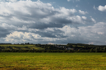 Obraz premium Landscape with field and blue sky.