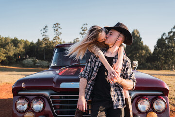 Loving couple kissing in retro car
